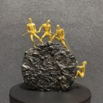 4 Persons Climbing on The Rock