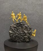 4 Persons Climbing on The Rock